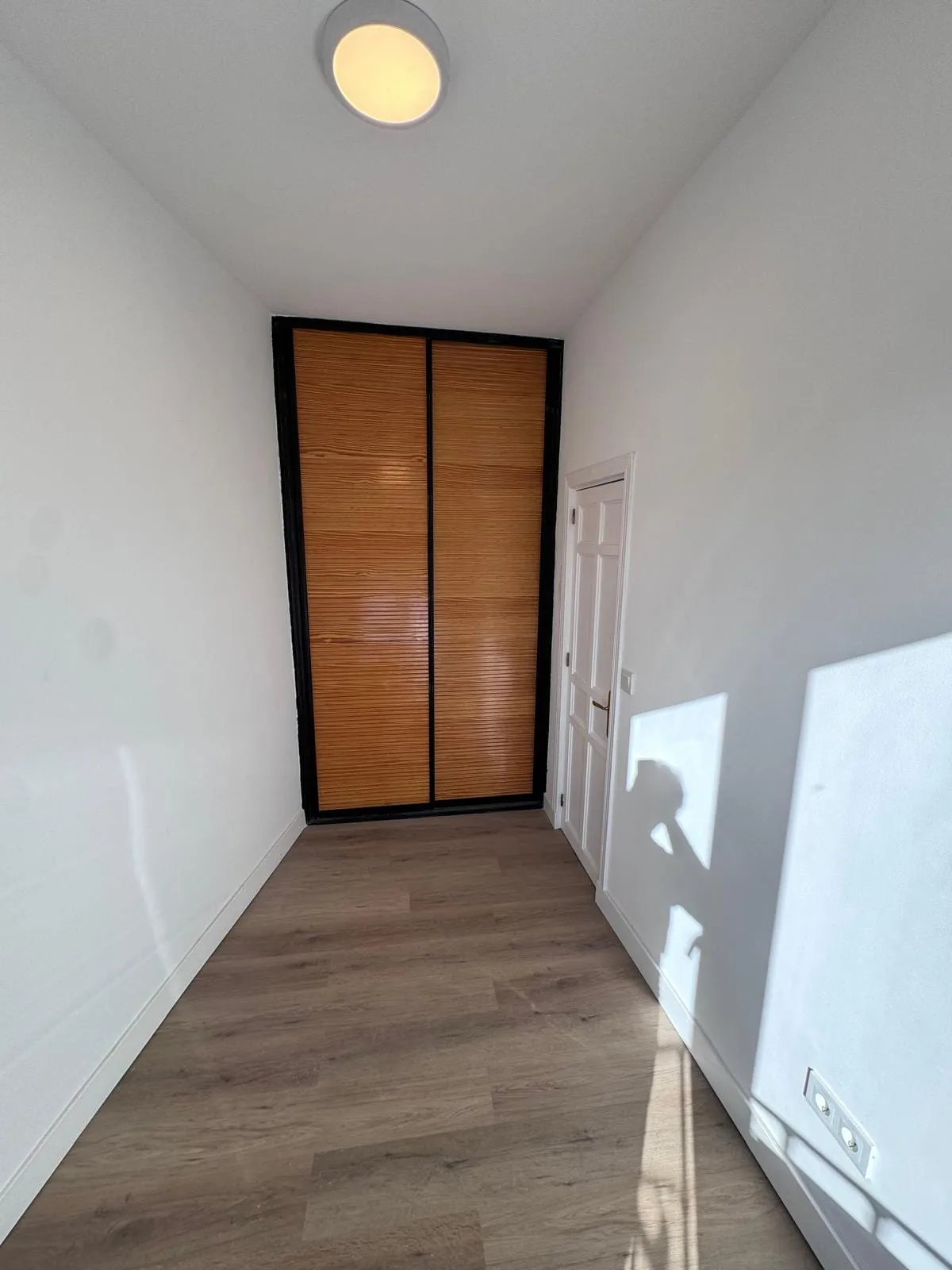 Armario empotrado de puertas correderas al fondo del pasillo